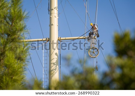 Worker repairing a high voltage industrial power energy line. Great for energy, safety and technology themes : Almada, Portugal - September 26, 2008