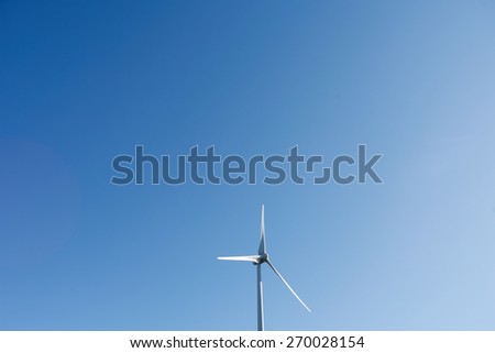 Wind Turbines on a modern windmill farm for alternative energy production. Electricity is powered ecological and considered better for the environment over oil and other fossil fuels.