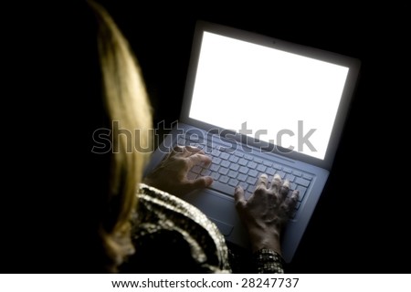 female woman typing a letter in the keyboard of Stylish laptop computer with Isolated white screen.