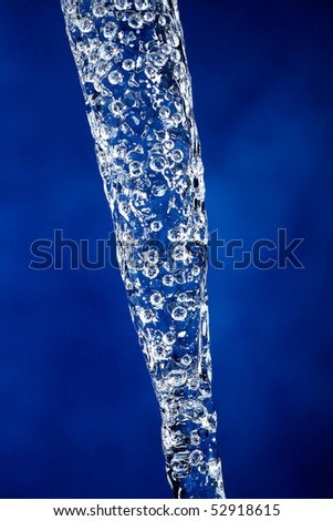 Close-up of frozen water, with beautiful blue background. Great for drink, freshness and cosmetic themes. Taken with technical flash strobe.