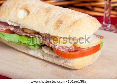 Tasty sandwich with salamy, tomatoes and smoked cheese