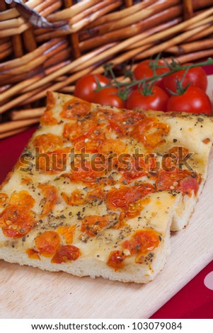 Typical italian focaccia bread with cherry tomatoes on top
