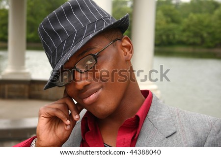 A homosexual man posing with his hand on the side of his face