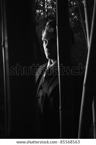 A mysterious man in shadows, black and white