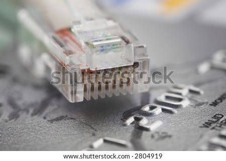 Credit card and a network cable representing online shopping.