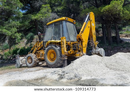 Excavator digging the earth in the forest