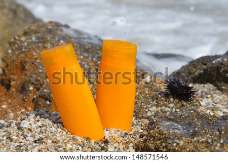 suntan lotion bottle in the sand