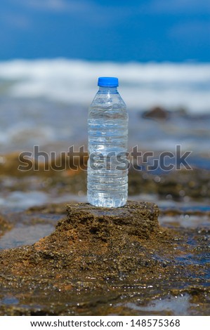 pet bottle with water on the sea sand