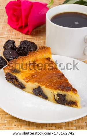 Romantic dinner from prunes and coffee pie against a pink rose