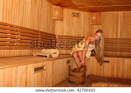Young attractive blond woman in a steam room