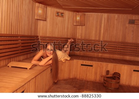 Young attractive blond woman in a steam room