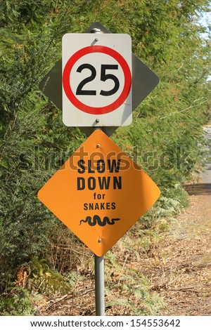 Australian road sign warning to slow down for snakes.