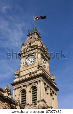 Clock tower of the old post office in Bendigo, Australia, flying the Australian flag.