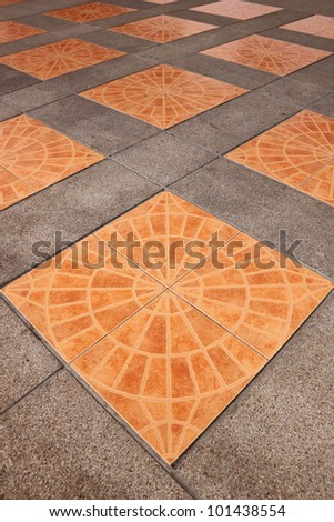 Orange square tiles on the pavement