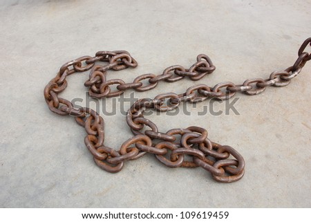 Several links of a rusty old chain.