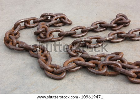Several links of a rusty old chain.
