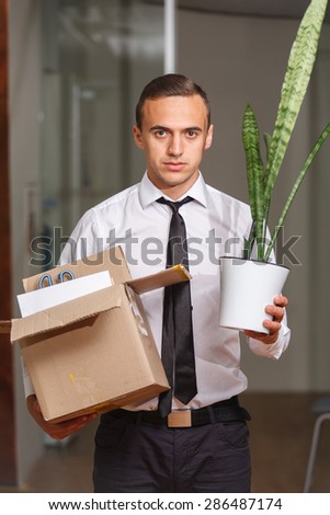 Dejected just fired an office worker with personal items in a box