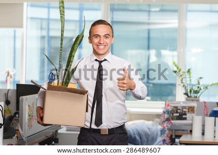 Happy just fired an office worker with box of personal stuff