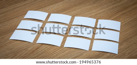 Many business cards on a wooden desk