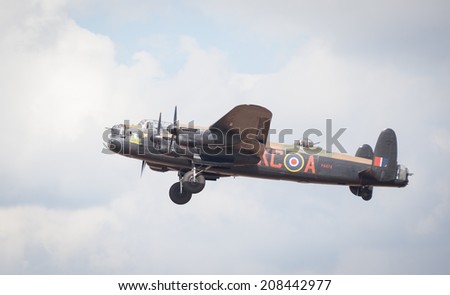 CLEETHORPES, ENGLAND JULY 27TH: Lancster Bomber from Battle of Britain Memorial flight performs a fly past Cleethropes airshow on 27th July 2014 in Cleethorpes England.