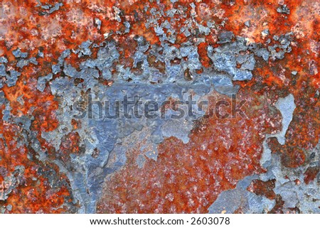 detailed macro shot of a patch of paint flecked rust, strong colours and interesting textures.