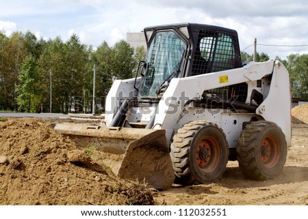 Small bulldozer is gaining ground in the bucket