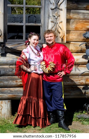 A young boy and a beautiful Russian girl in national costumes