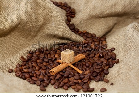 Mountain lake of coffee beans and cinnamon sticks in a boat