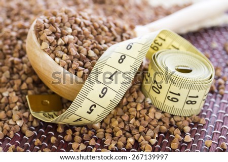 Measuring tape lying on buckwheat, which is used in the diets