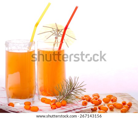 Two glasses with sea buckthorn fruit drink and sea-buckthorn berries