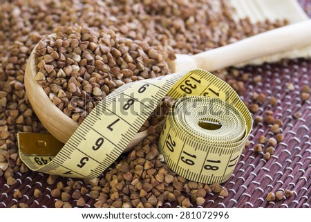 Measuring tape lying on buckwheat, which is used in the diets
