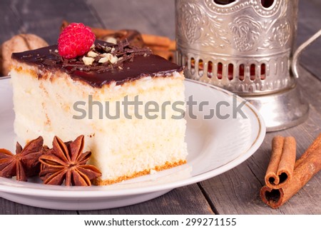 Cake with chocolate cream and a cup of tea in the cup holder of Soviet times