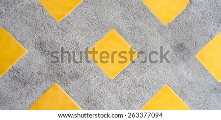 Real concrete mixed with yellow square ceramic texture background