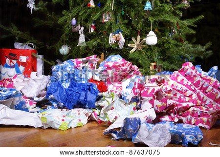 A Mess of Wrinkled Wrapping Paper Scattered Under the Christmas Tree