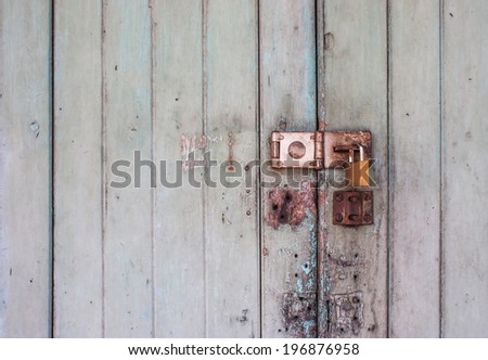 padlock with old wooden background.