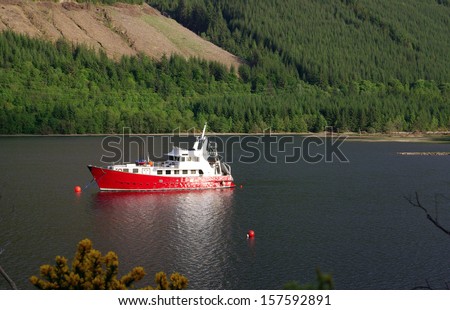 The red ship is in the harbor in Highland, Scotland