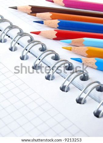 spiral notebook and set of color pencils