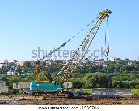 truck crane on a construction site against urban panoramic view