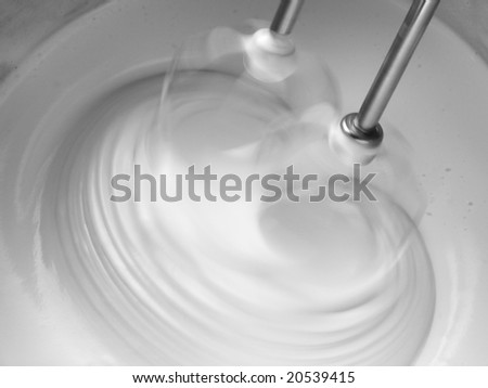 motion blurred dough beating with electric mixer close up