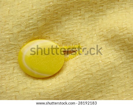 yellow clothes fragment with button