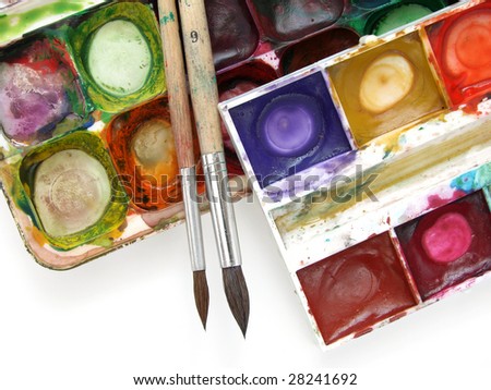 dirty watercolor paints set with brushes after using