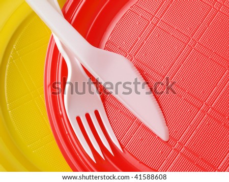 red and yellow disposable plates with fork and knife