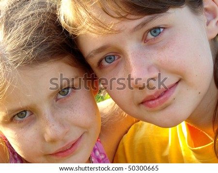 two pretty freckles sisters summer outdoor portrait