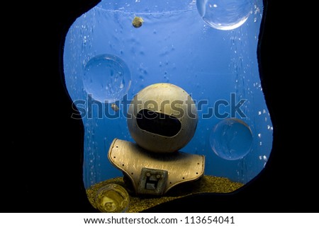 Old fashion diving helmet submerged in the water.
