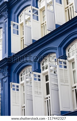 Blue building with white shutters and windows. China Town, Singapore