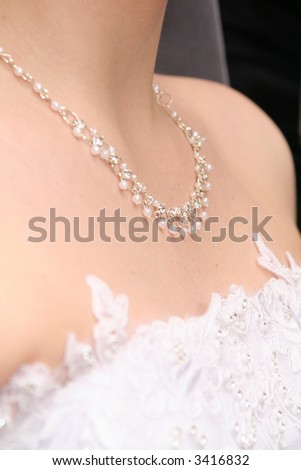 Bride`s necklace - garland of pearls on pure skin of neck