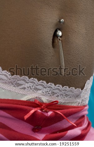 Young woman belly with piercing