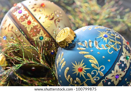 Two ornamental Christmas ornaments with eyelash ribbon.