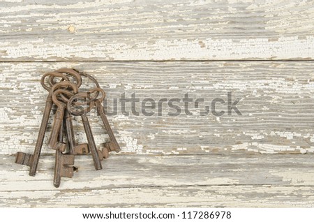 Fob of old skeleton keys on a weathered surface