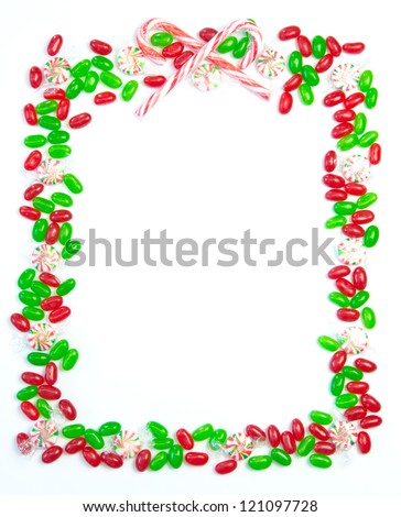 Bright festive Christmas page border with red and green jelly beans, hard candies and candy canes.